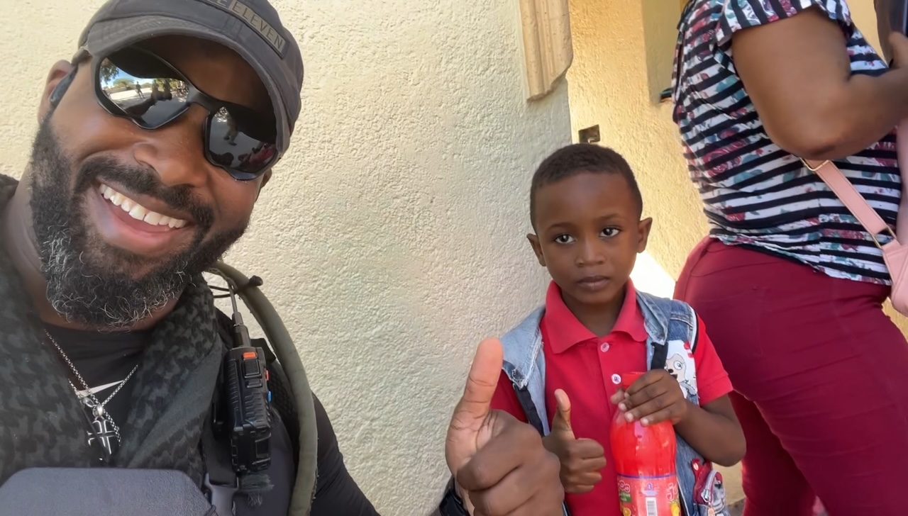 Man of Peace on the ground with a child in the community